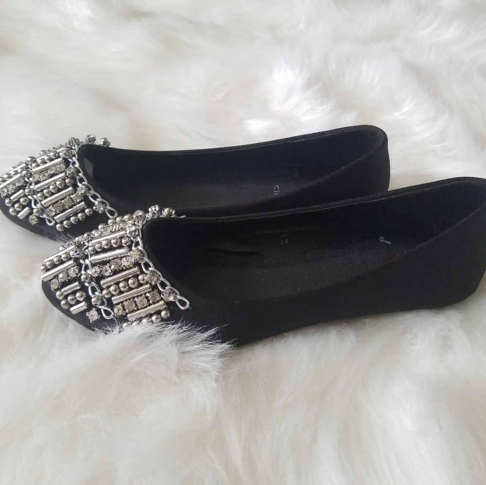 Black flats with silver design.